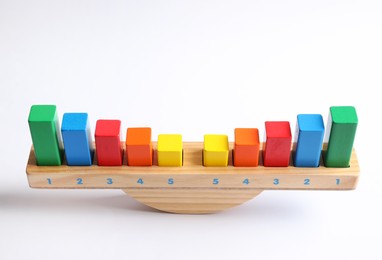 Wooden scale with colorful blocks isolated on white. Montessori toy