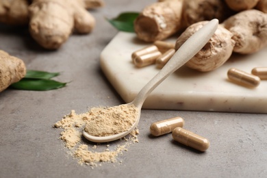 Dry, capsuled and fresh ginger on grey table