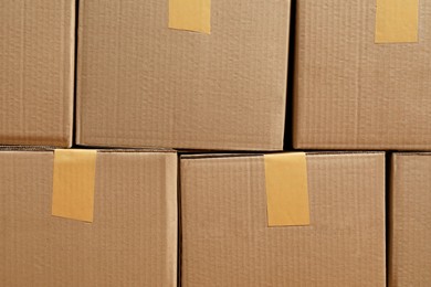 Photo of Stack of many cardboard boxes as background. Packaging goods