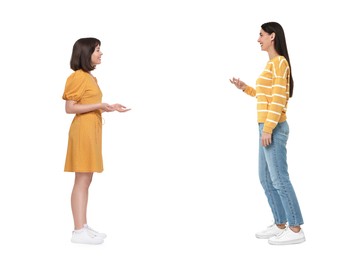 Two women talking on white background. Dialogue