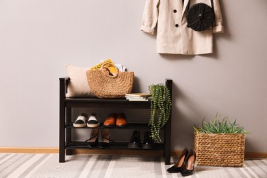 Hallway interior with stylish furniture, clothes and accessories