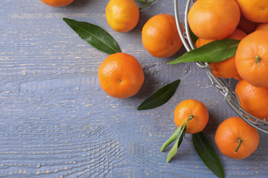 Fresh ripe tangerines on grey wooden table, flat lay. Space for text