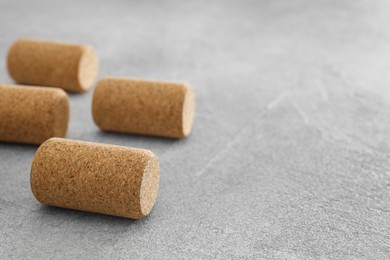 Wine bottle corks on light grey table, closeup. Space for text