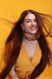 Photo of Portrait of smiling woman on yellow background