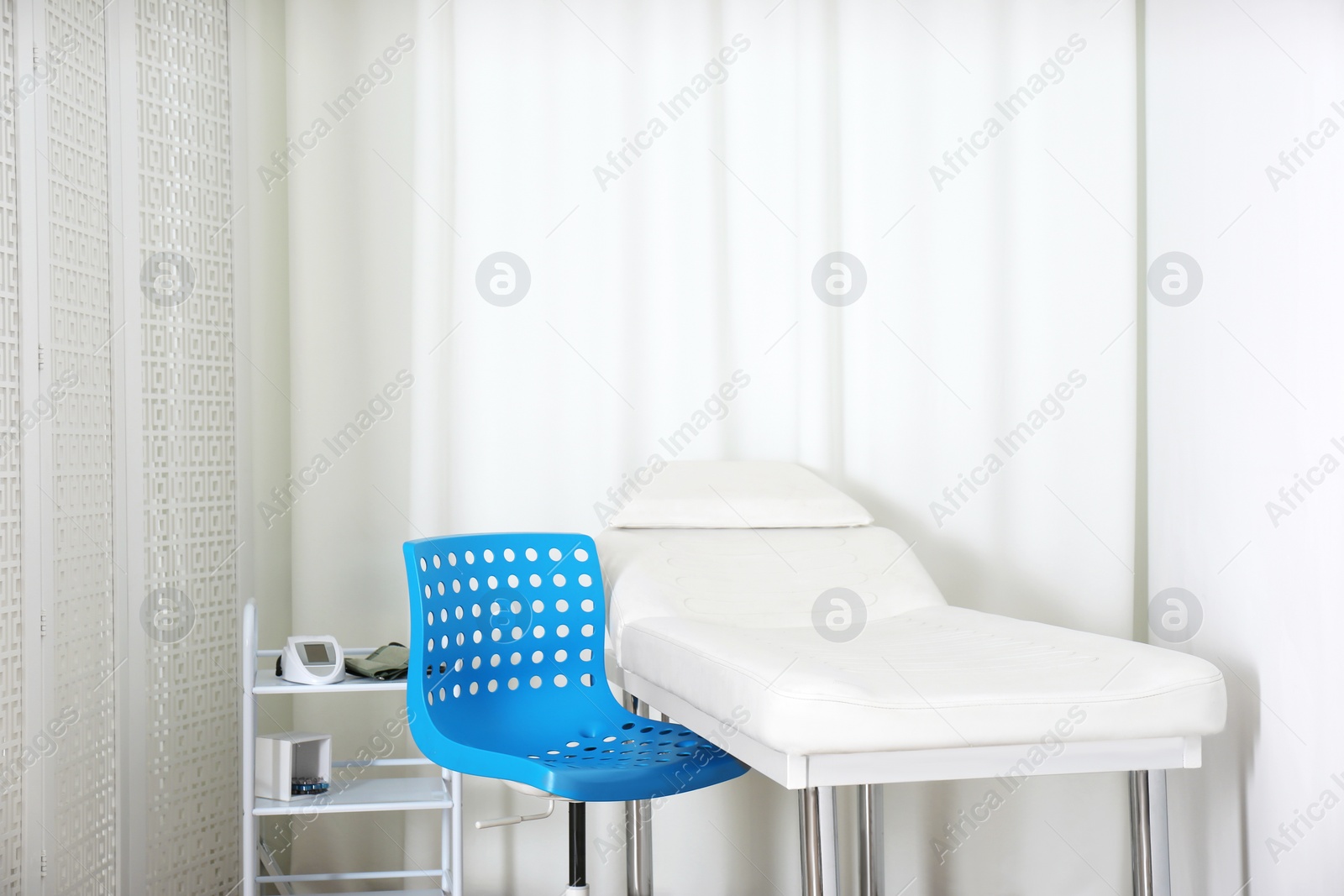 Photo of Empty examination couch in modern medical office