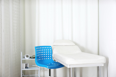 Empty examination couch in modern medical office