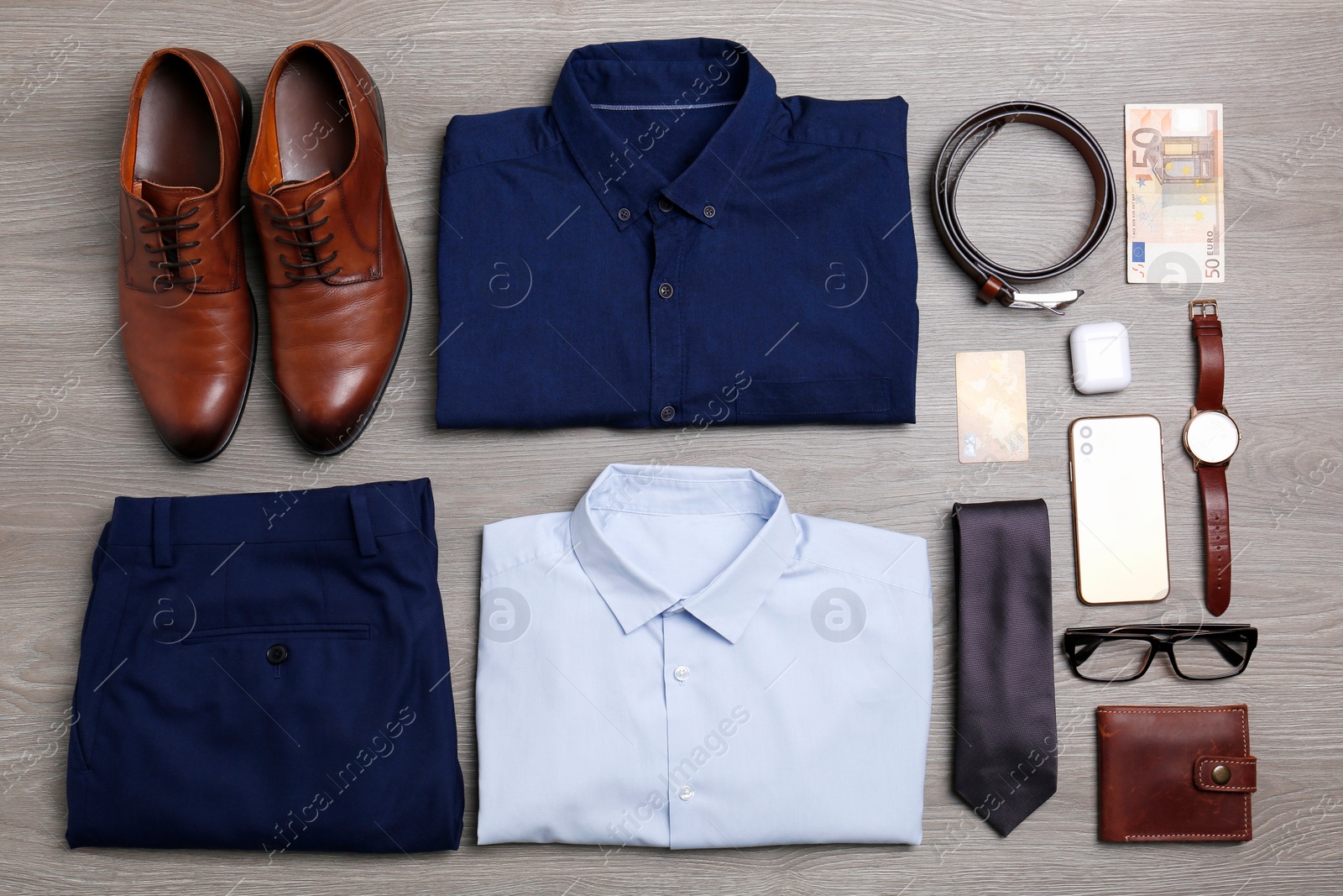 Photo of Flat lay composition with clothes, shoes and accessories on wooden background. Packing for business trip