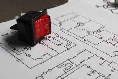 Photo of Wiring diagrams and electric switch on table, closeup