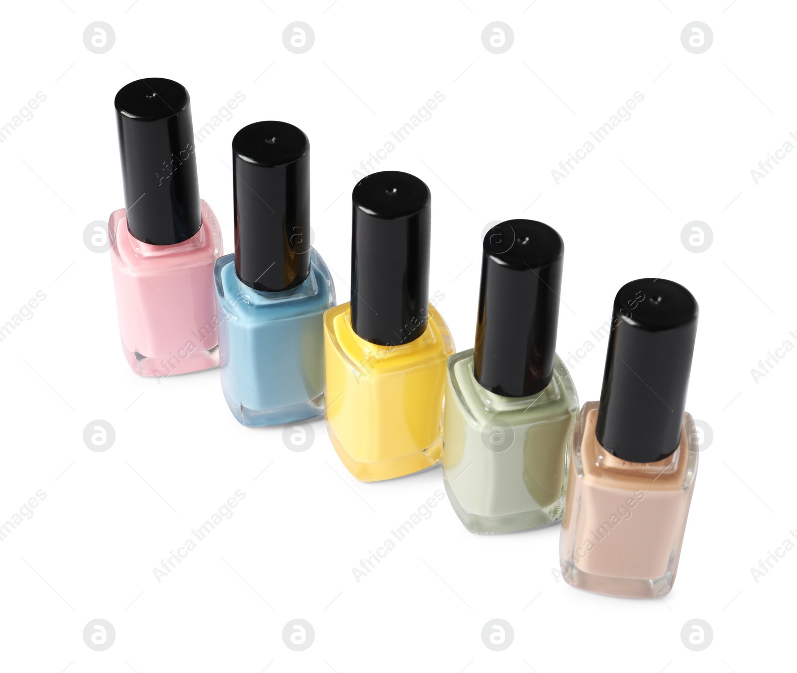Photo of Pastel nail polishes in bottles isolated on white