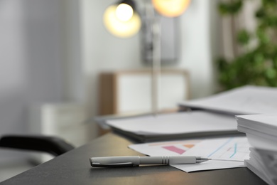 Pen and different documents on office table. Space for text