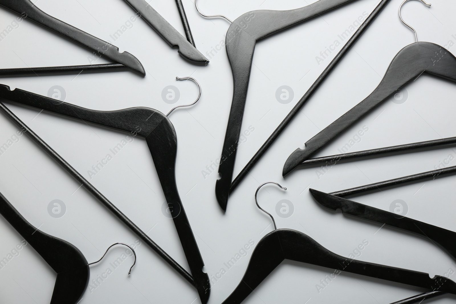 Photo of Black hangers on light gray background, flat lay