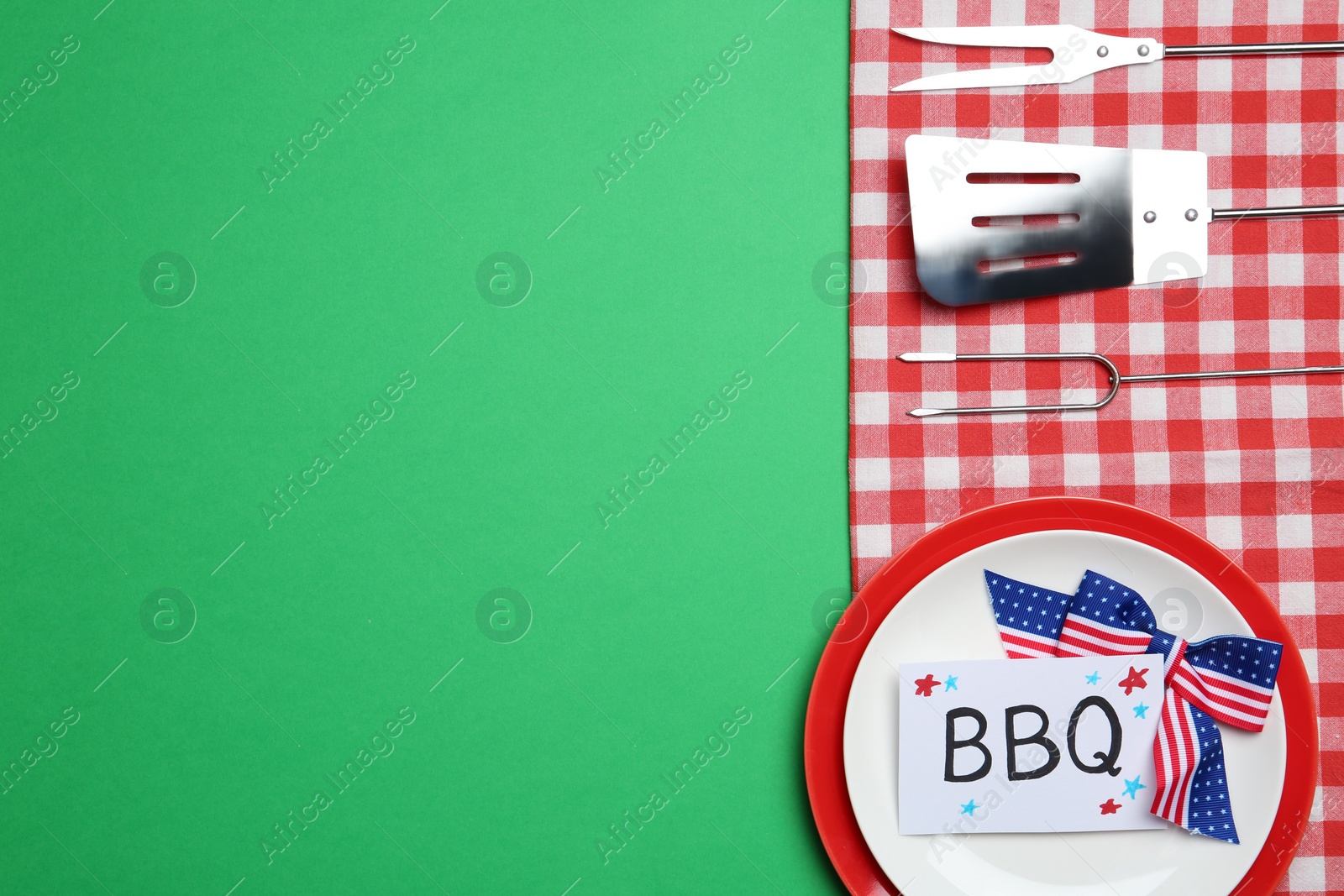 Photo of Set of dishware and barbecue tools on color background, flat lay with space for text. USA Independence Day
