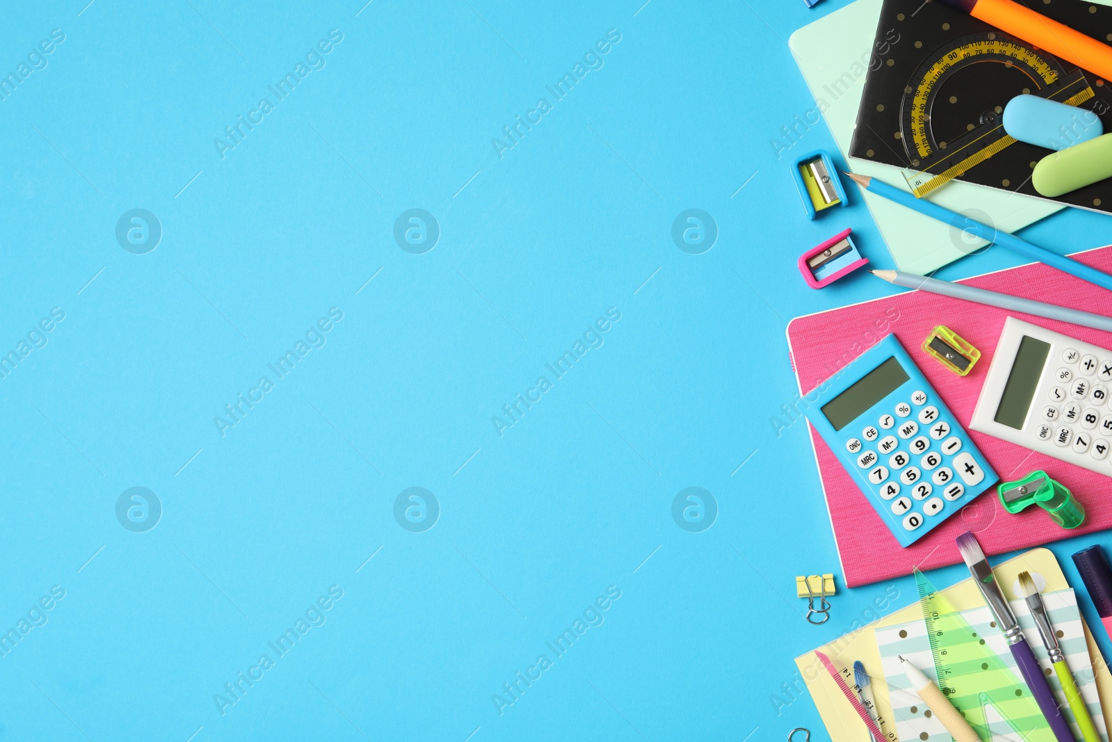 Photo of Different stationery on light blue background, flat lay with space for text. Back to school