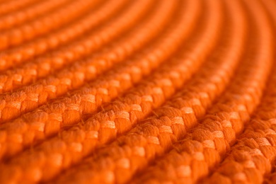 Photo of Texture of orange wicker mat as background, closeup view