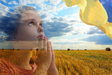 Image of Pray for Ukraine. Multiple exposure of little girl, beautiful agricultural field with hay bales and Ukrainian flag