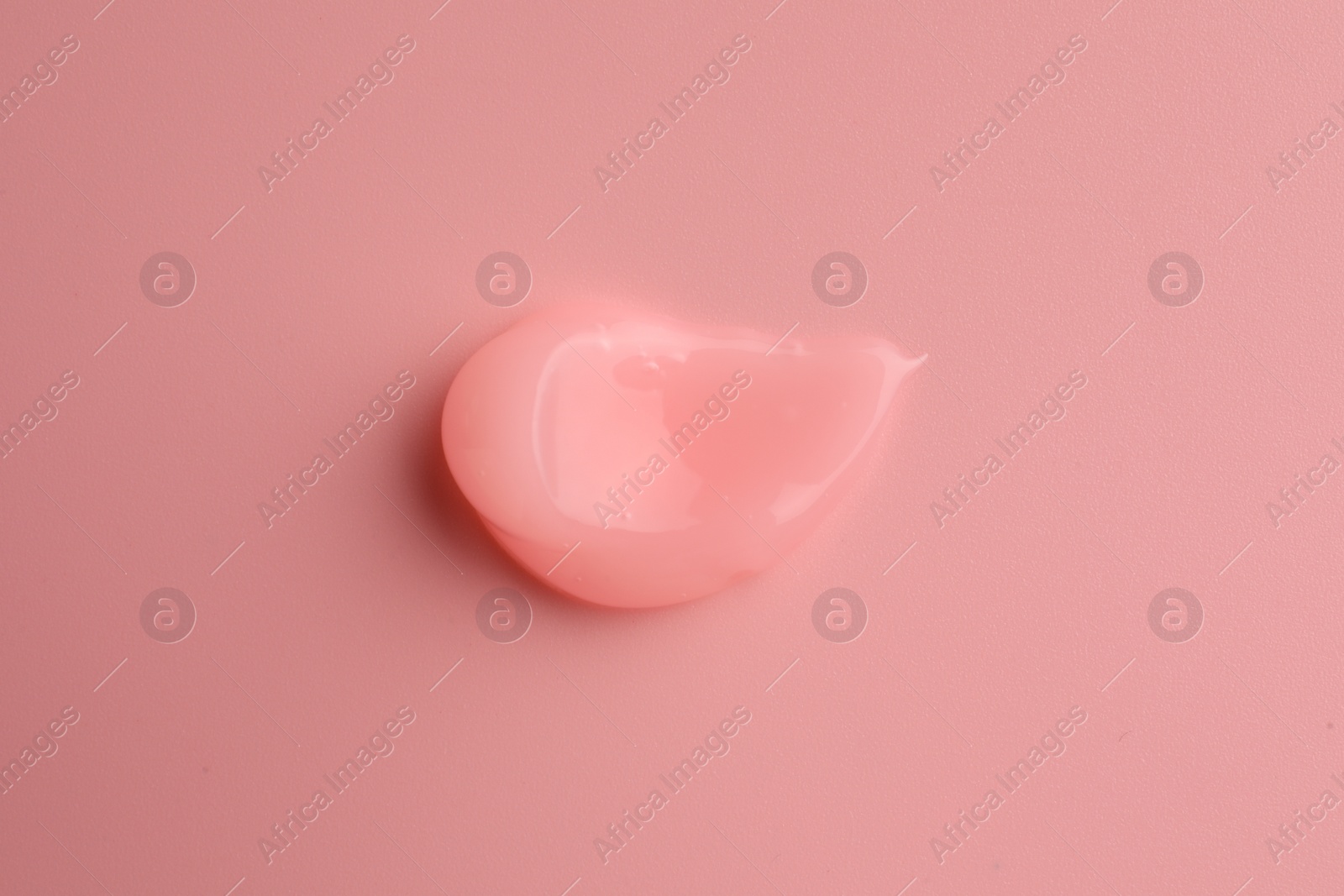 Photo of Sample of cosmetic gel on pink background, top view