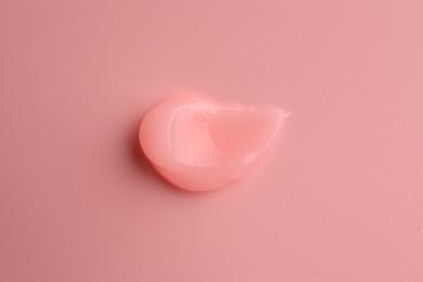 Photo of Sample of cosmetic gel on pink background, top view