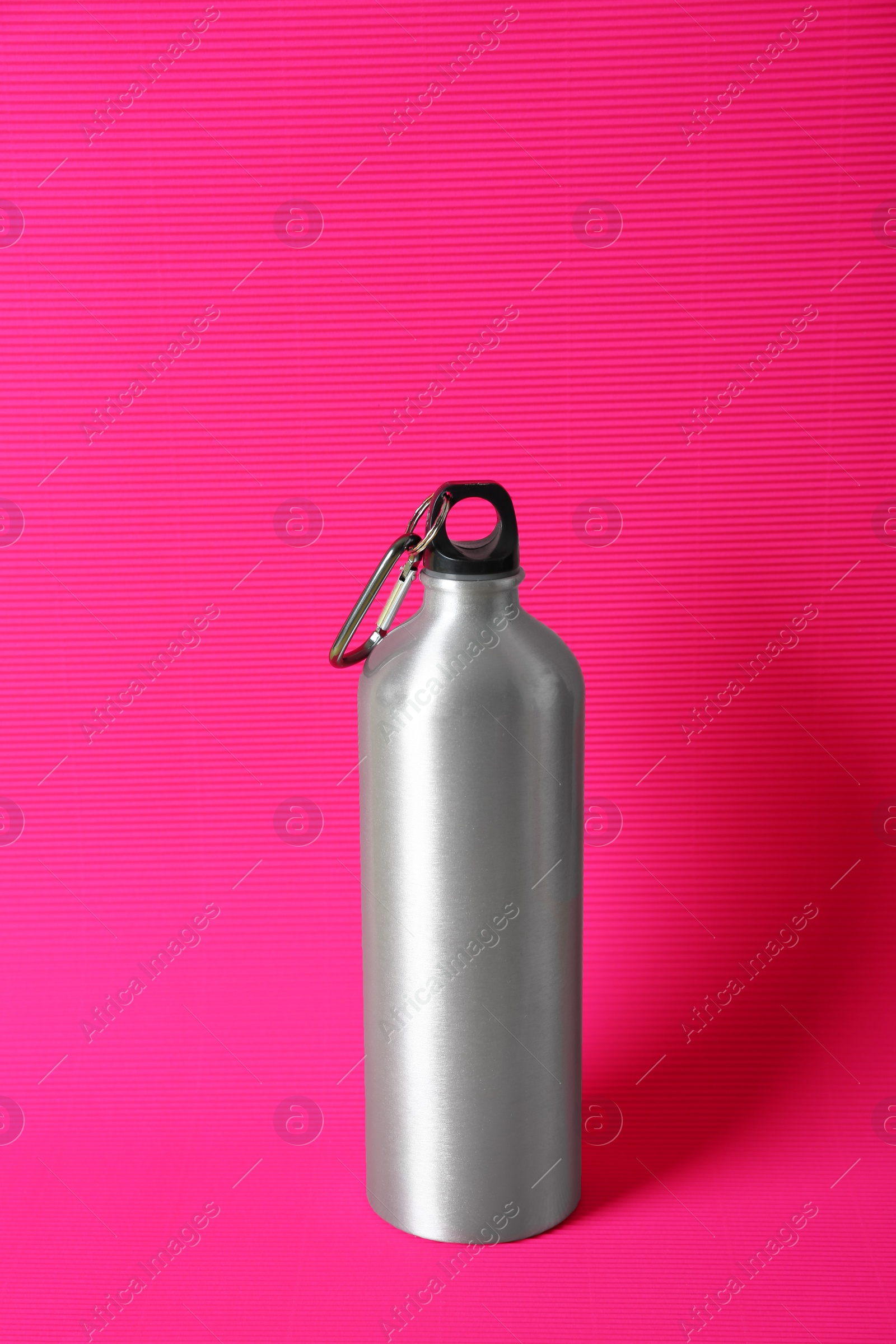 Photo of Sport bottle with water on color background. Healthy lifestyle