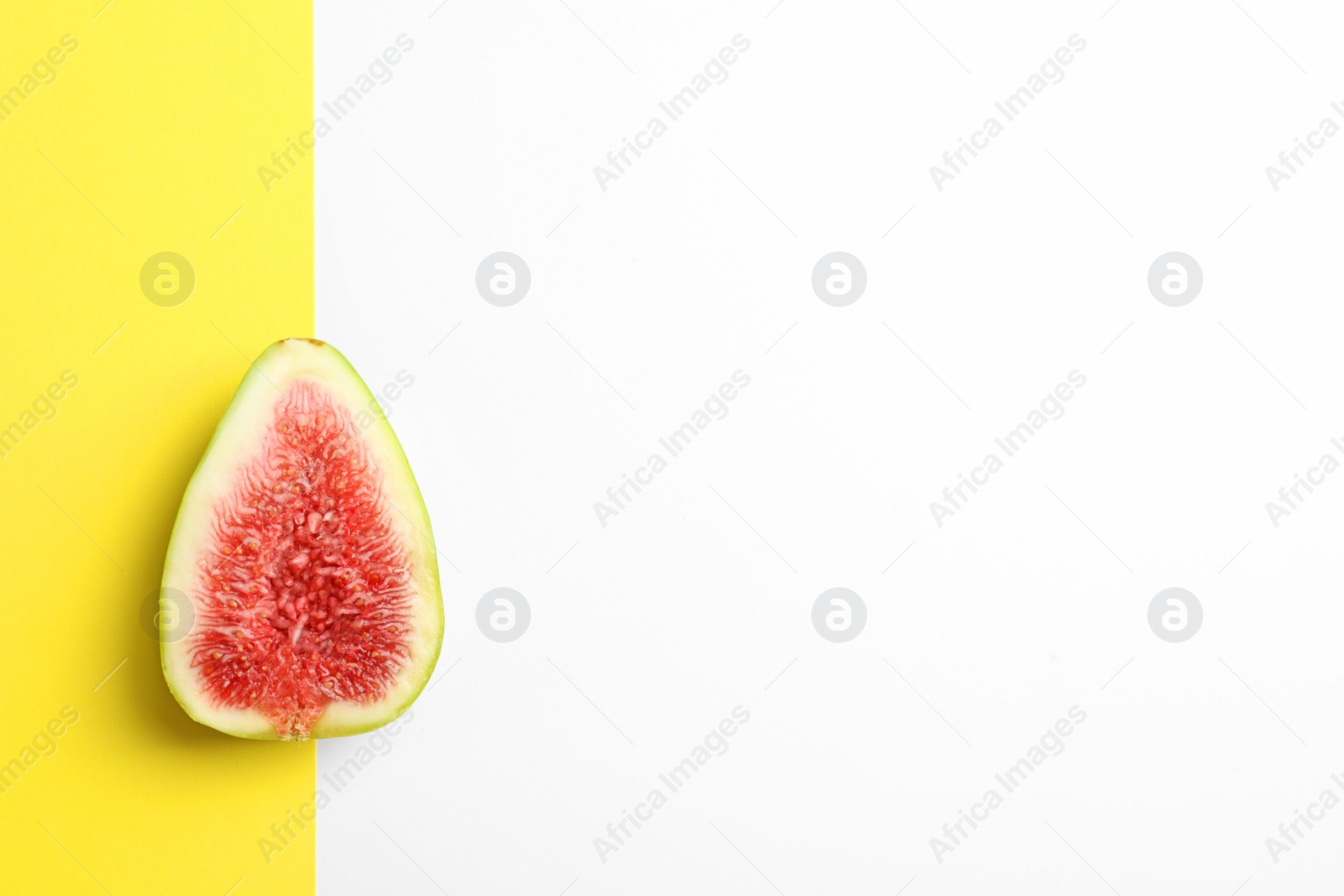 Photo of Fresh ripe fig slice on color background, top view. Space  for text