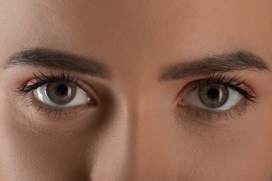 Photo of Evil eye. Young woman with scary eyes, closeup
