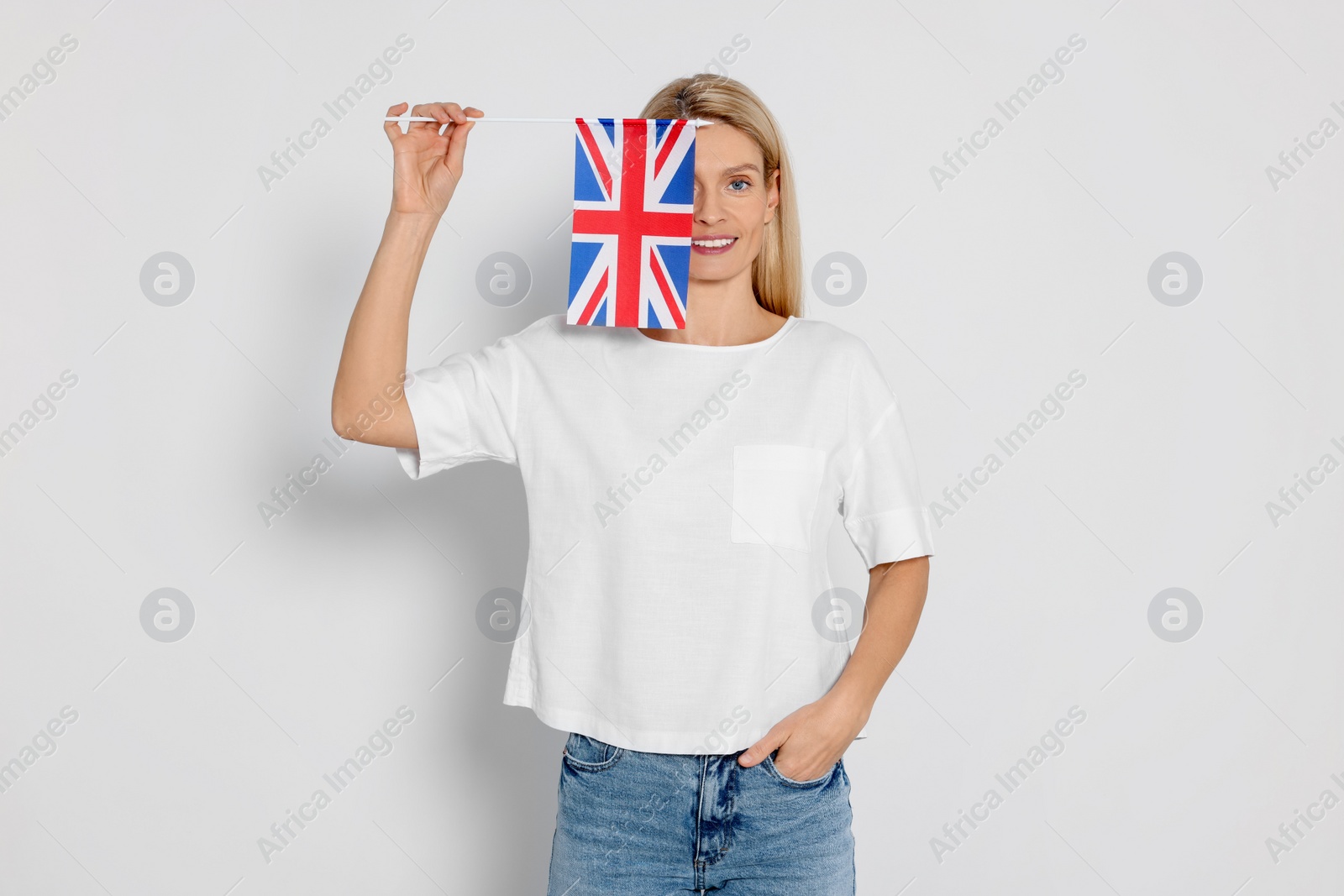 Photo of Woman with flag of United Kingdom on white background