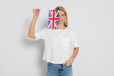 Woman with flag of United Kingdom on white background