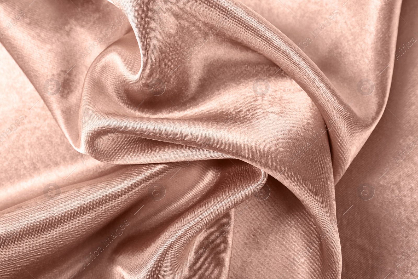 Photo of Texture of rose gold silk as background, closeup