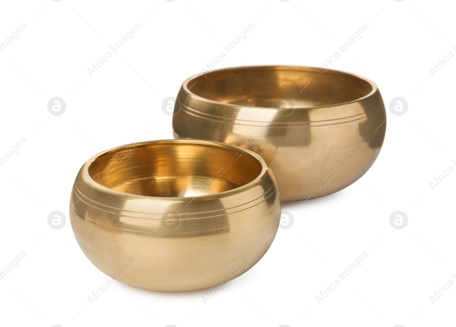 Photo of Two Tibetan singing bowls on white background