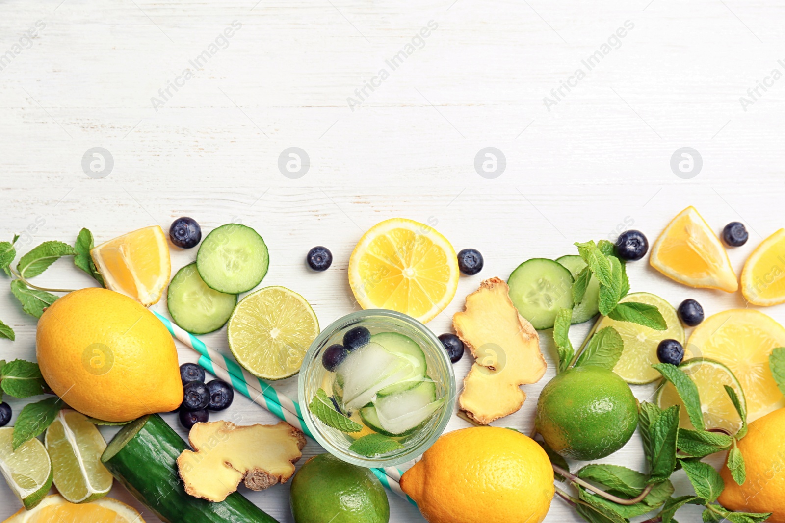 Photo of Flat lay composition with delicious natural lemonade on wooden background