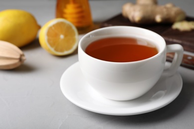 Cup of hot tea and natural cough remedies on table