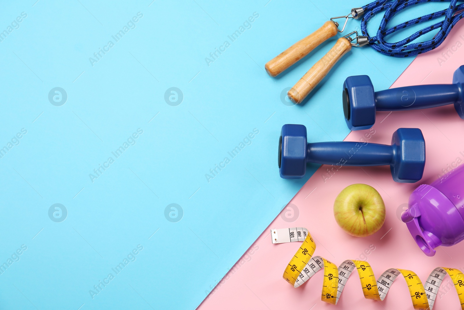 Photo of Flat lay composition with dumbbells on color background, space for text