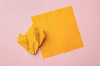 Photo of Orange reusable beeswax food wraps on pink background, top view