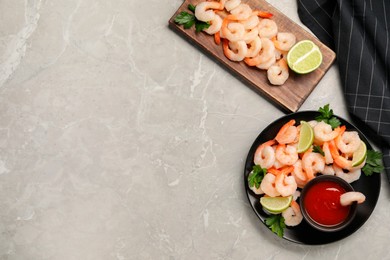 Tasty boiled shrimps with cocktail sauce, parsley and lime on light grey table, flat lay. Space for text