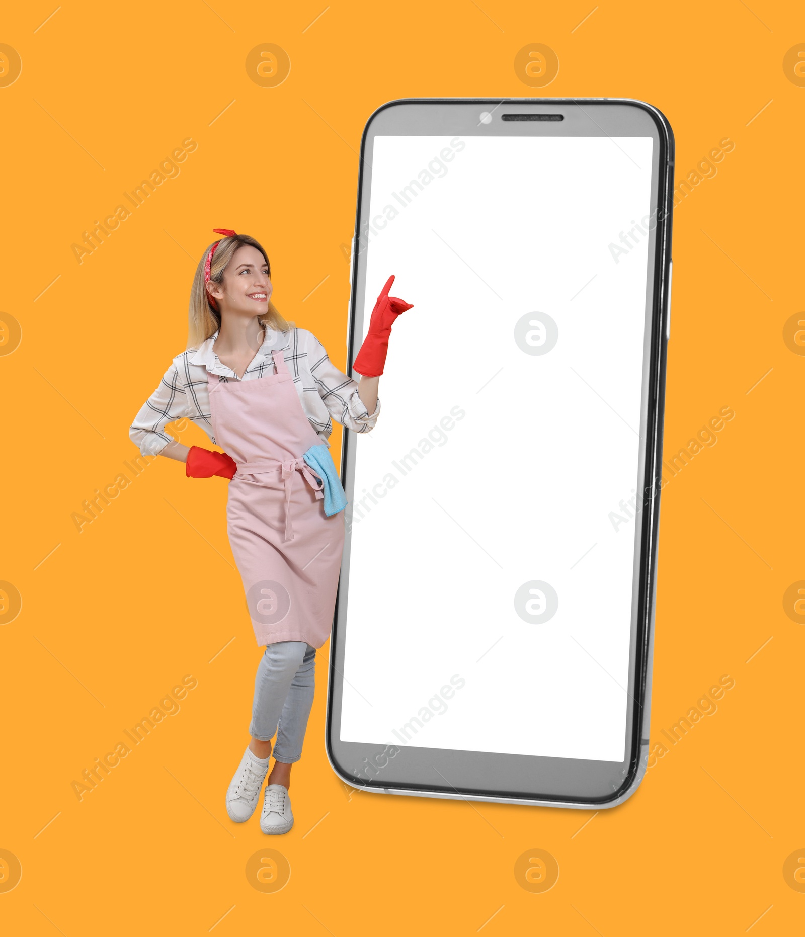 Image of Housewife using big smartphone on orange background