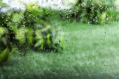 Photo of Window glass with rain drops as background, closeup