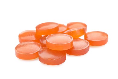 Photo of Many orange cough drops on white background