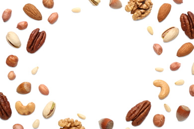 Different delicious nuts on white background, flat lay. Space for text