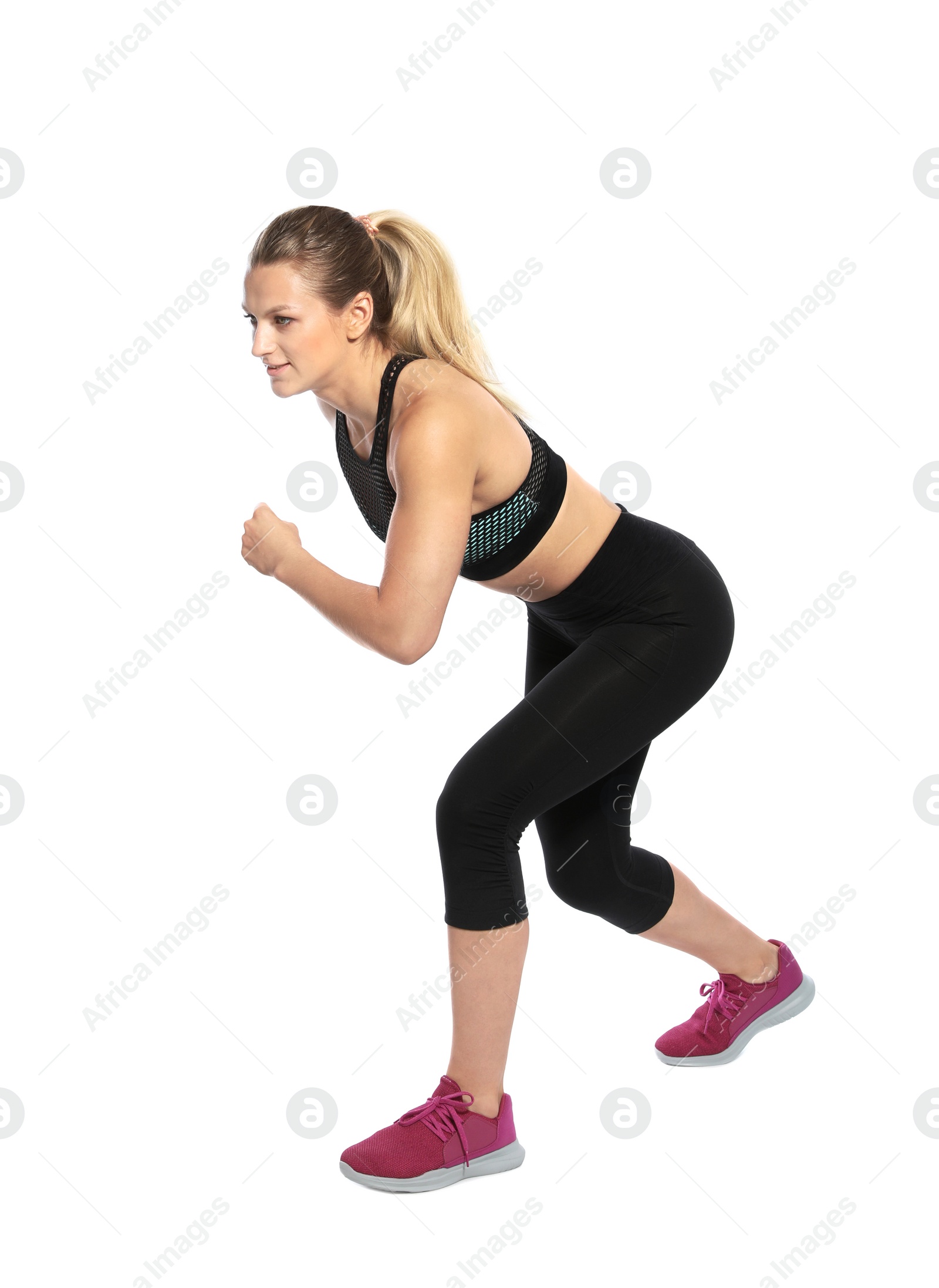 Photo of Young woman ready to run on white background