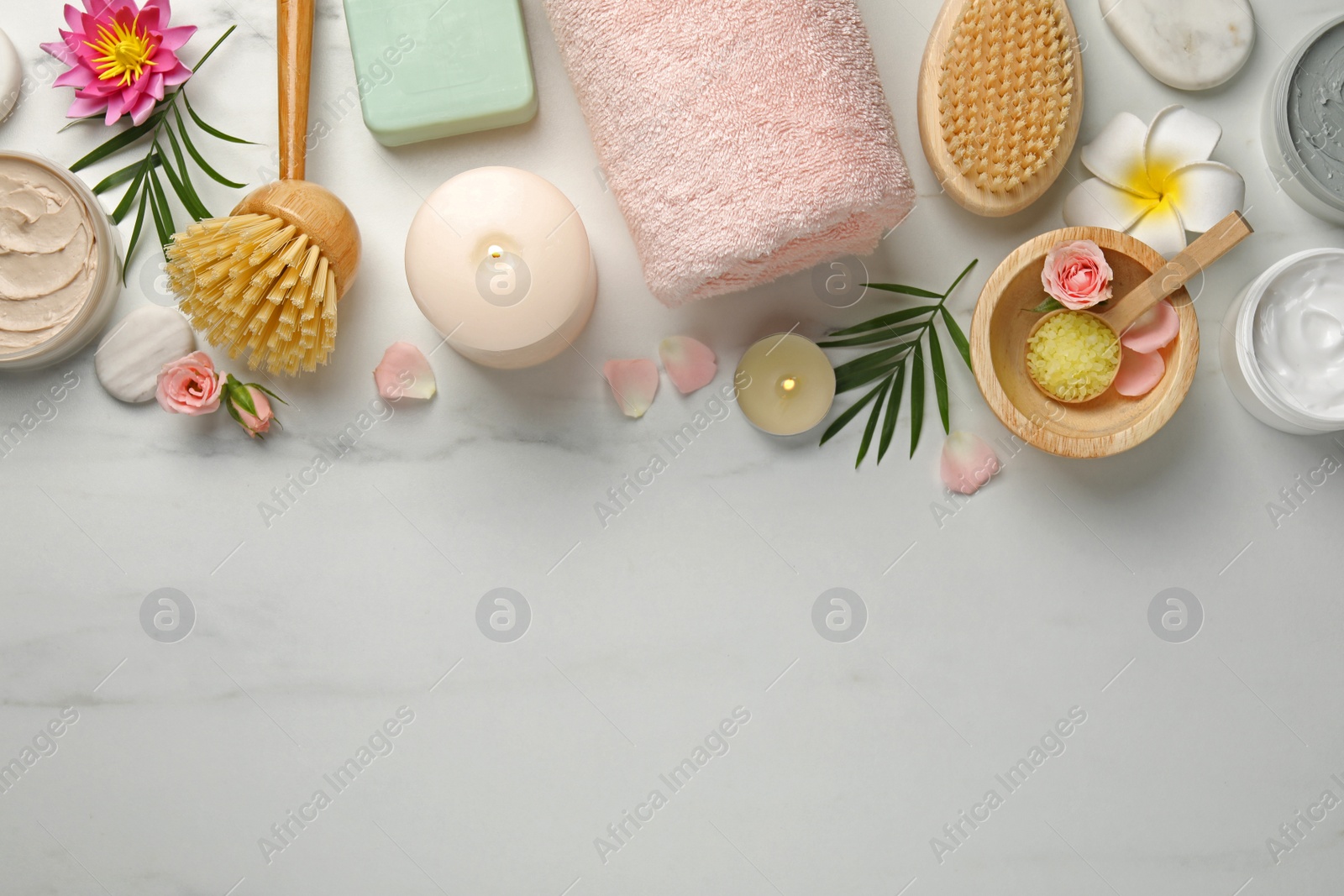 Photo of Flat lay composition with different spa products on white marble table. Space for text