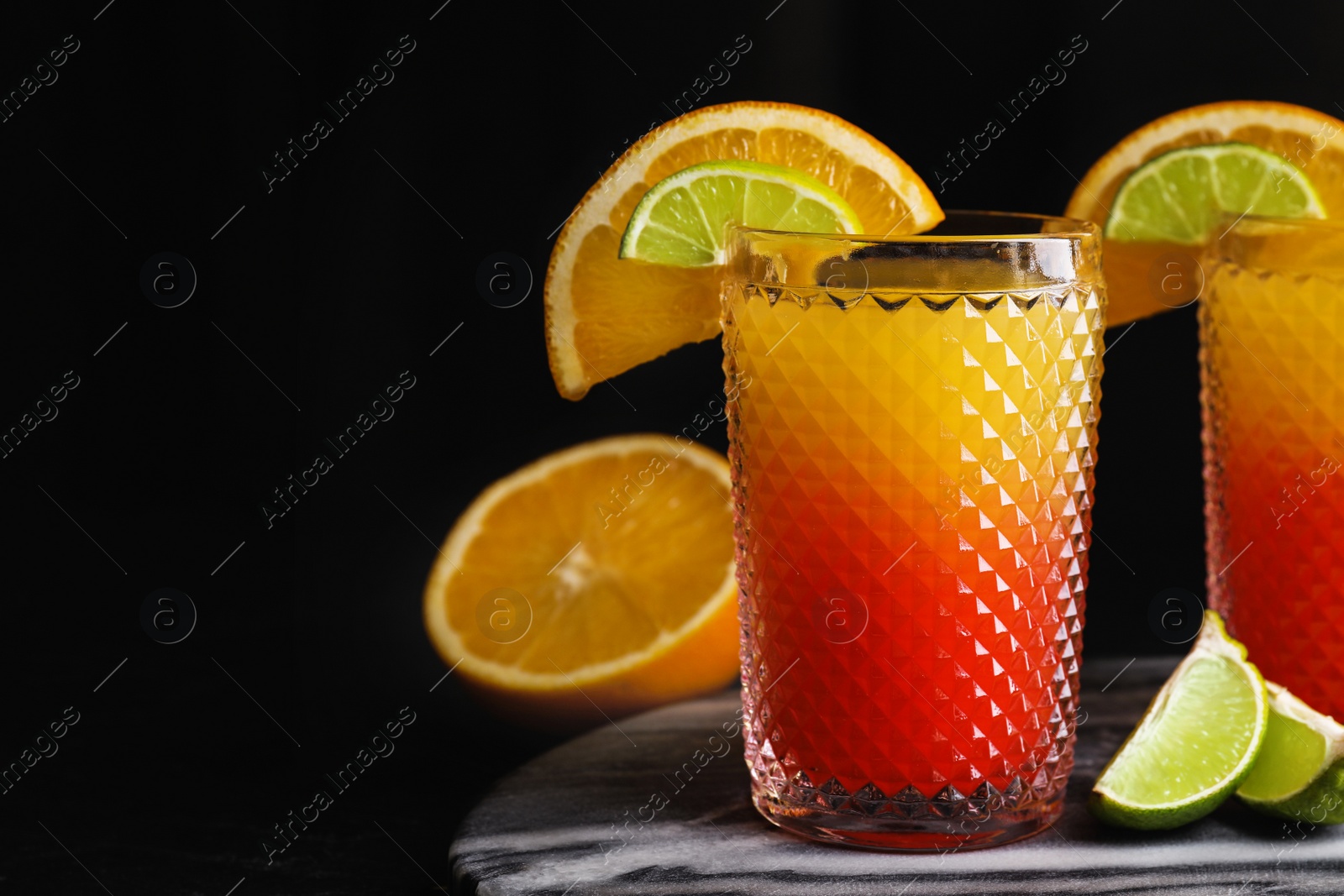 Photo of Fresh alcoholic Tequila Sunrise cocktail on marble board