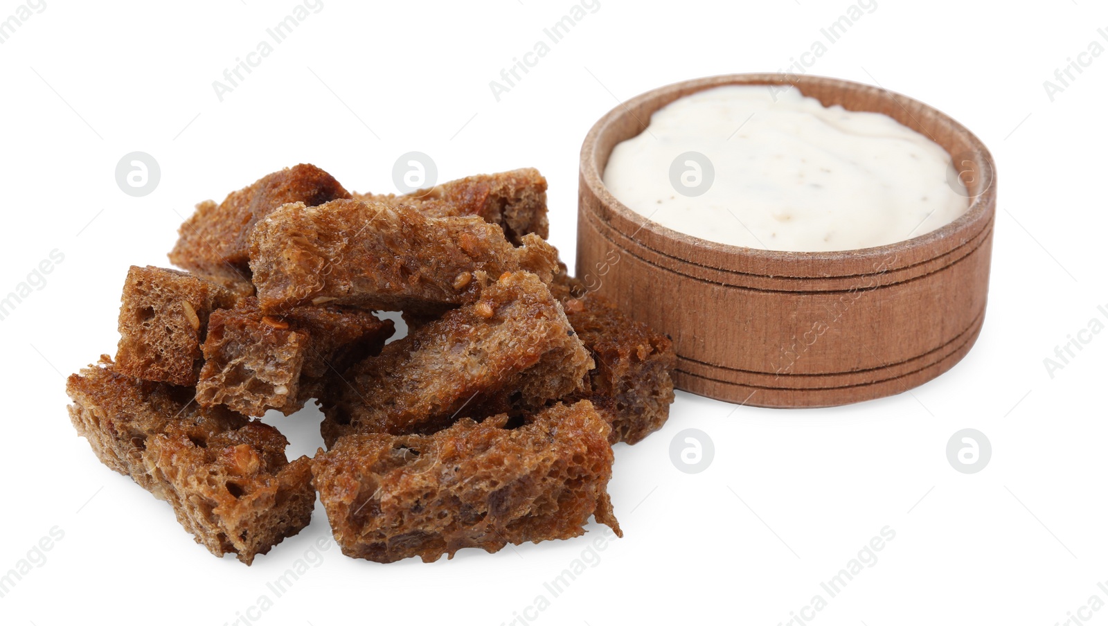 Photo of Heap of crispy rusks and sauce isolated on white