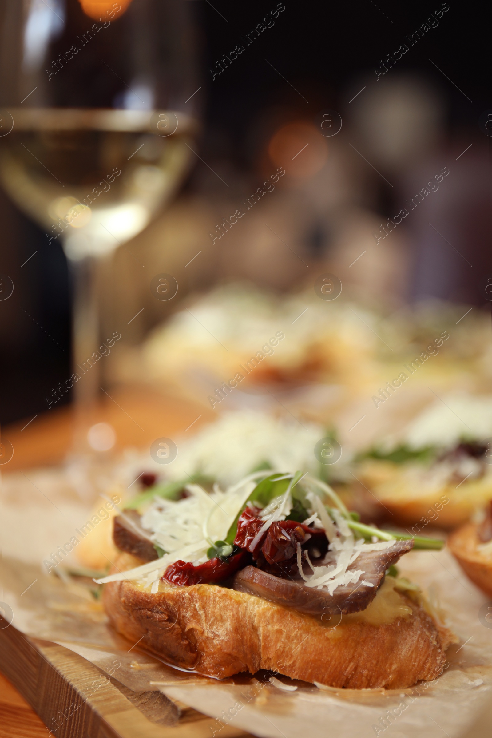 Photo of Delicious bruschettas with beef and cheese on table, closeup