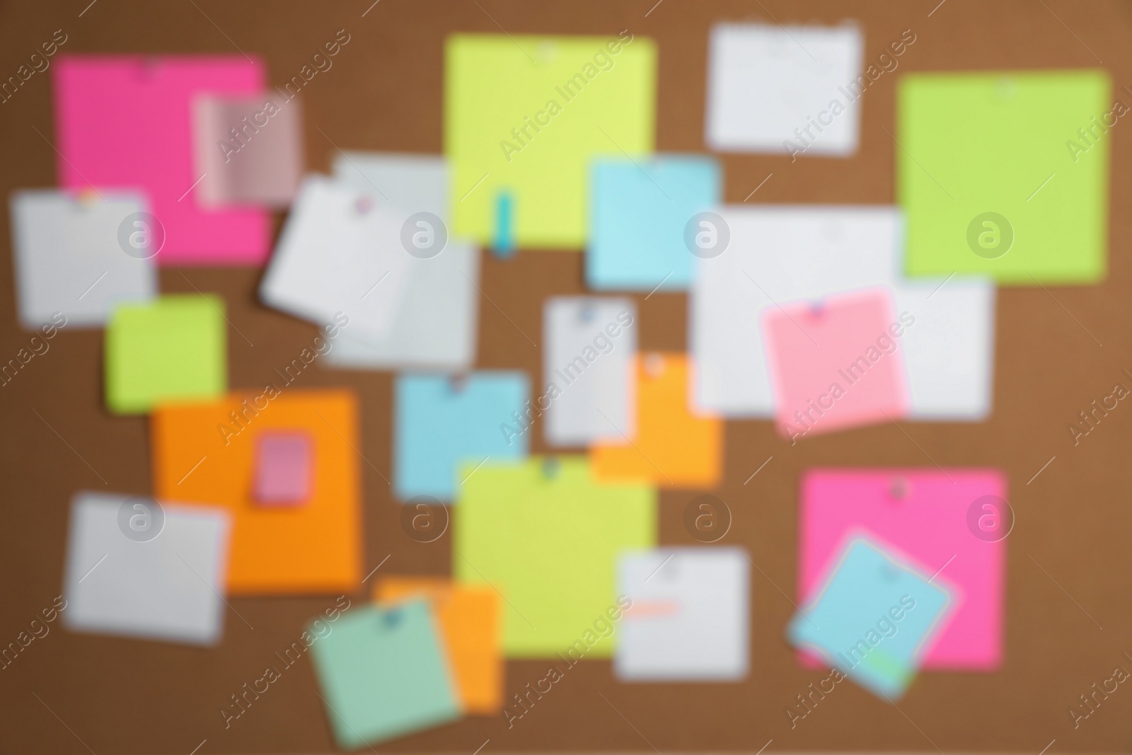 Photo of Blurred view of cork board with many colorful notes