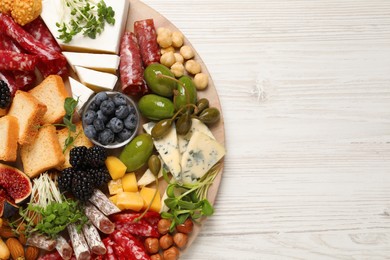 Photo of Different tasty appetizers on white wooden table, top view. Space for text