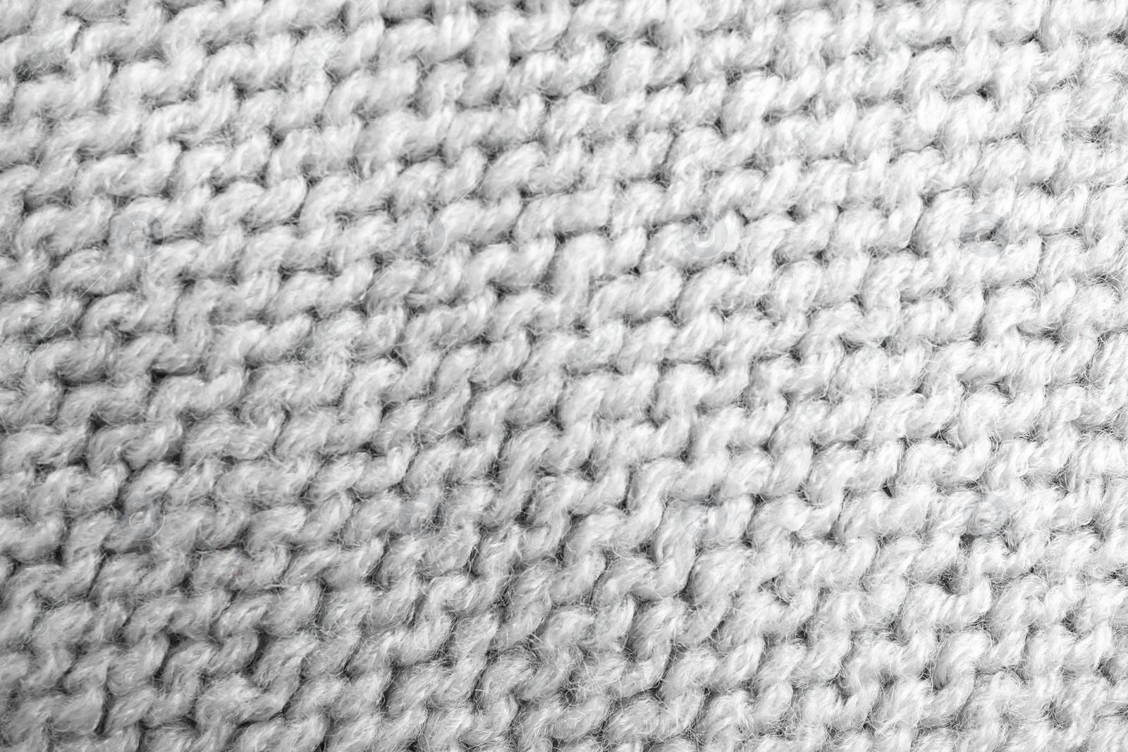 Photo of Grey knitted sweater as background, closeup view