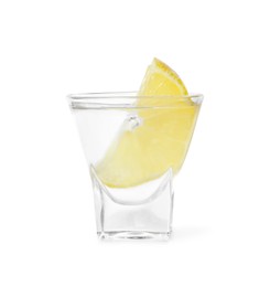 Photo of Shot glass of vodka with lemon isolated on white