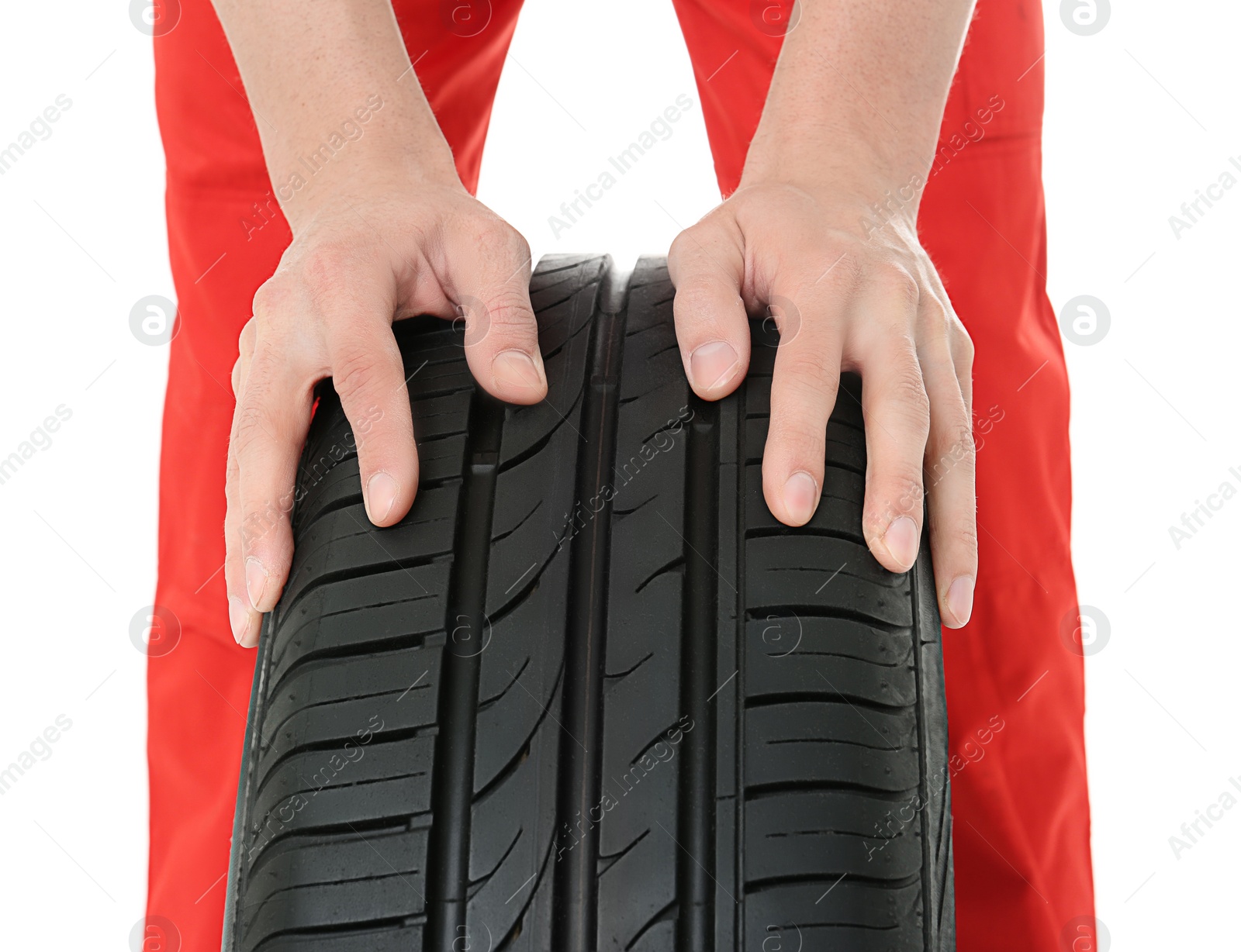 Photo of Hands of mechanic with car tire on white background