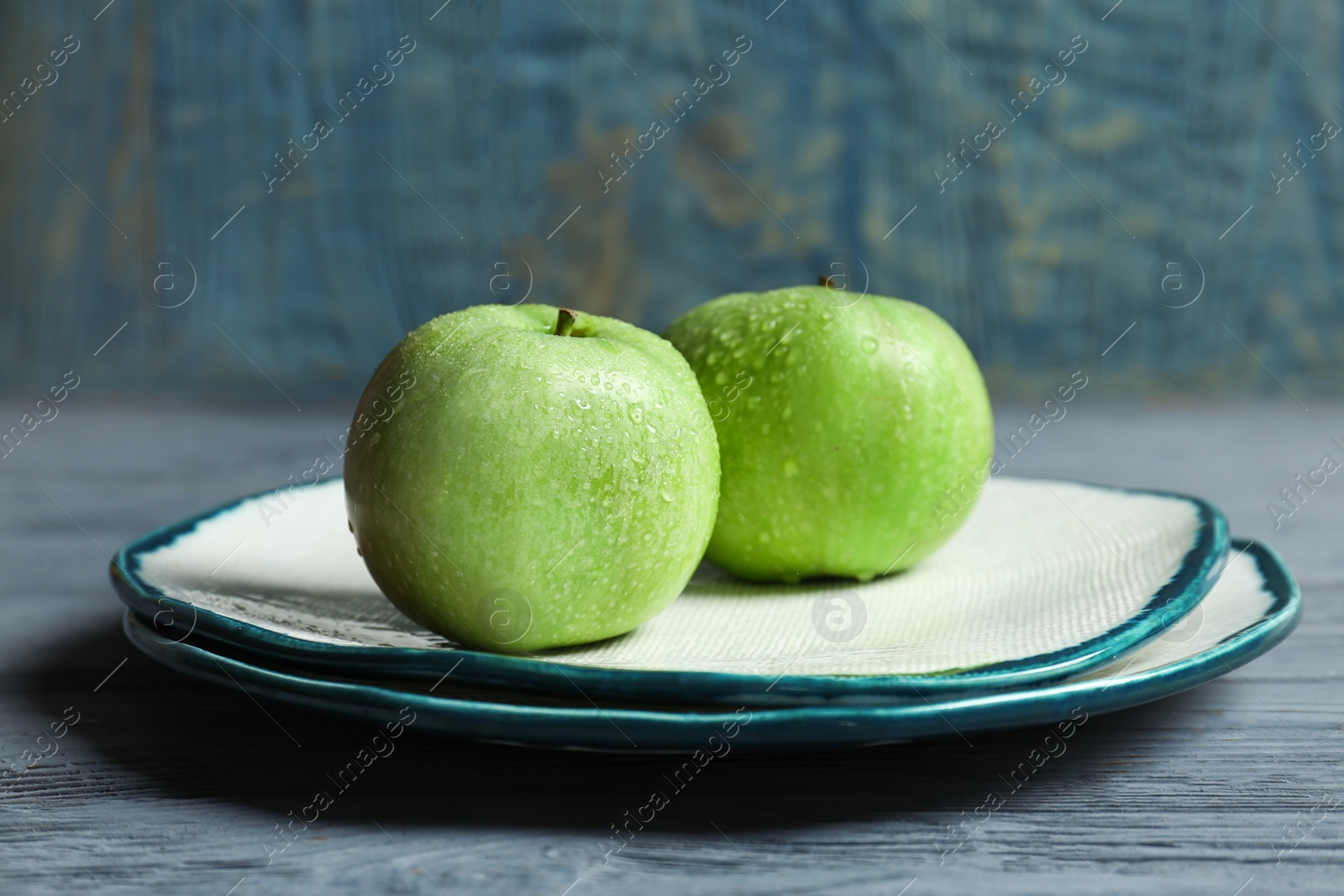 Photo of Plate with fresh green apples on wooden table