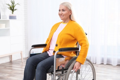 Mature woman sitting in wheelchair at home