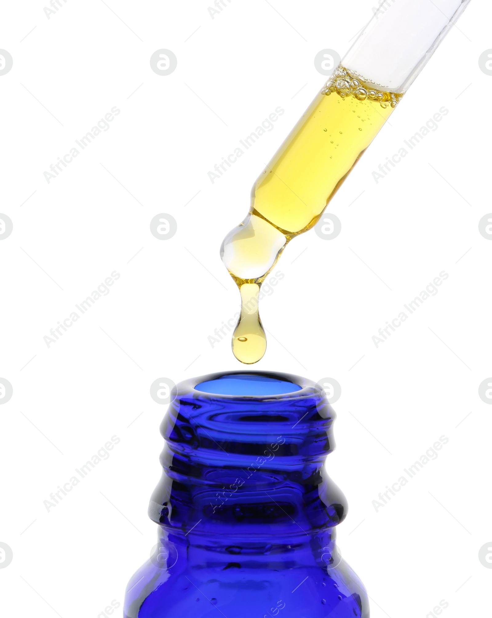 Photo of Dripping tincture from pipette into bottle isolated on white